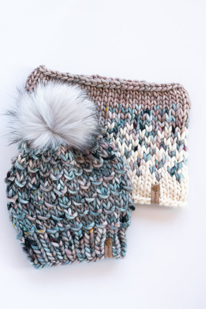 Blue speckled merino wool knitted hat and fair isle cowl on a white background