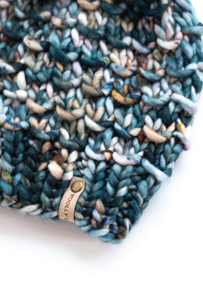 Close view of a green multicolor knit hat on a white background