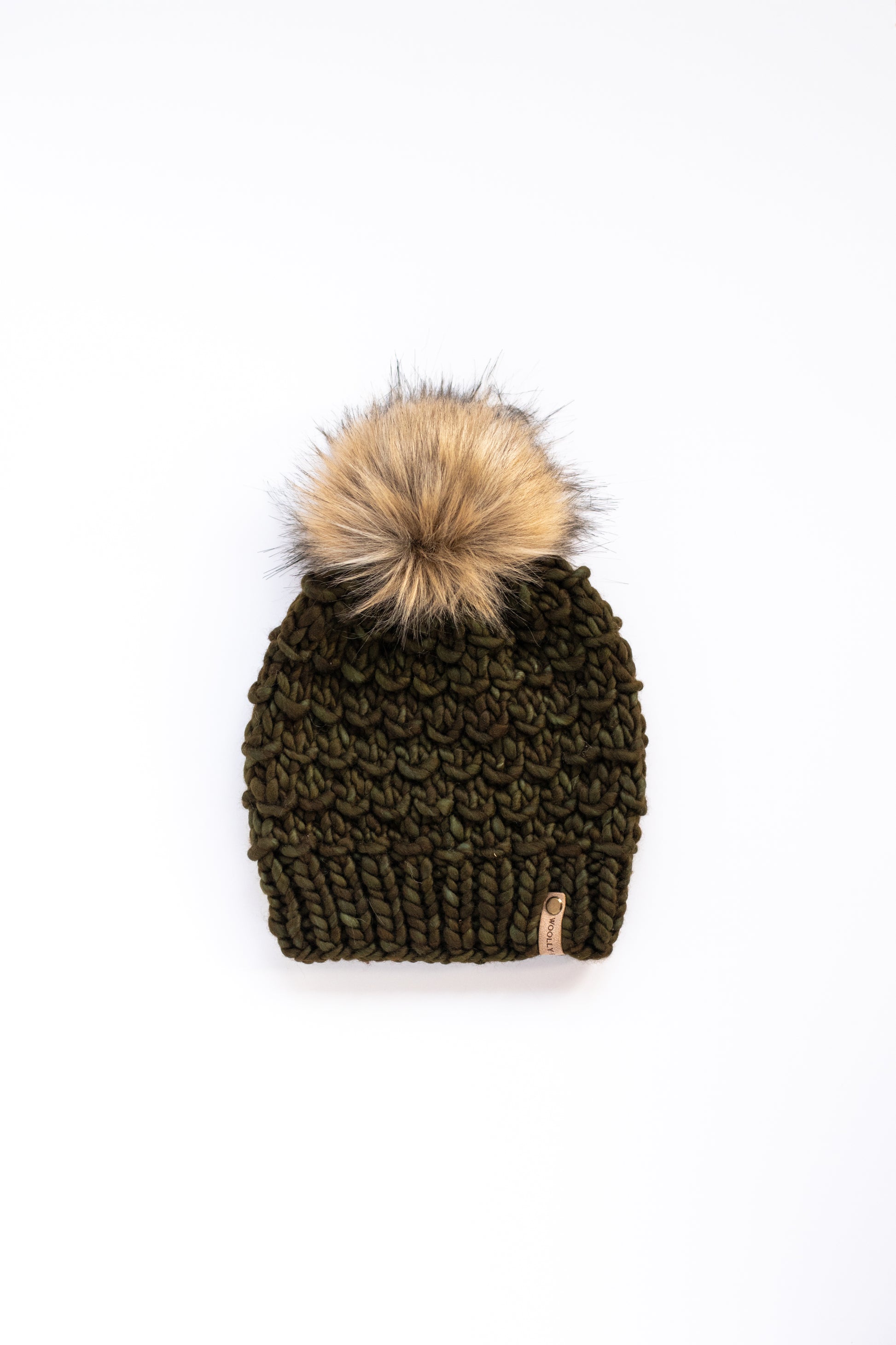 Olive green knitted beanie with a fur pom-pom on a white background