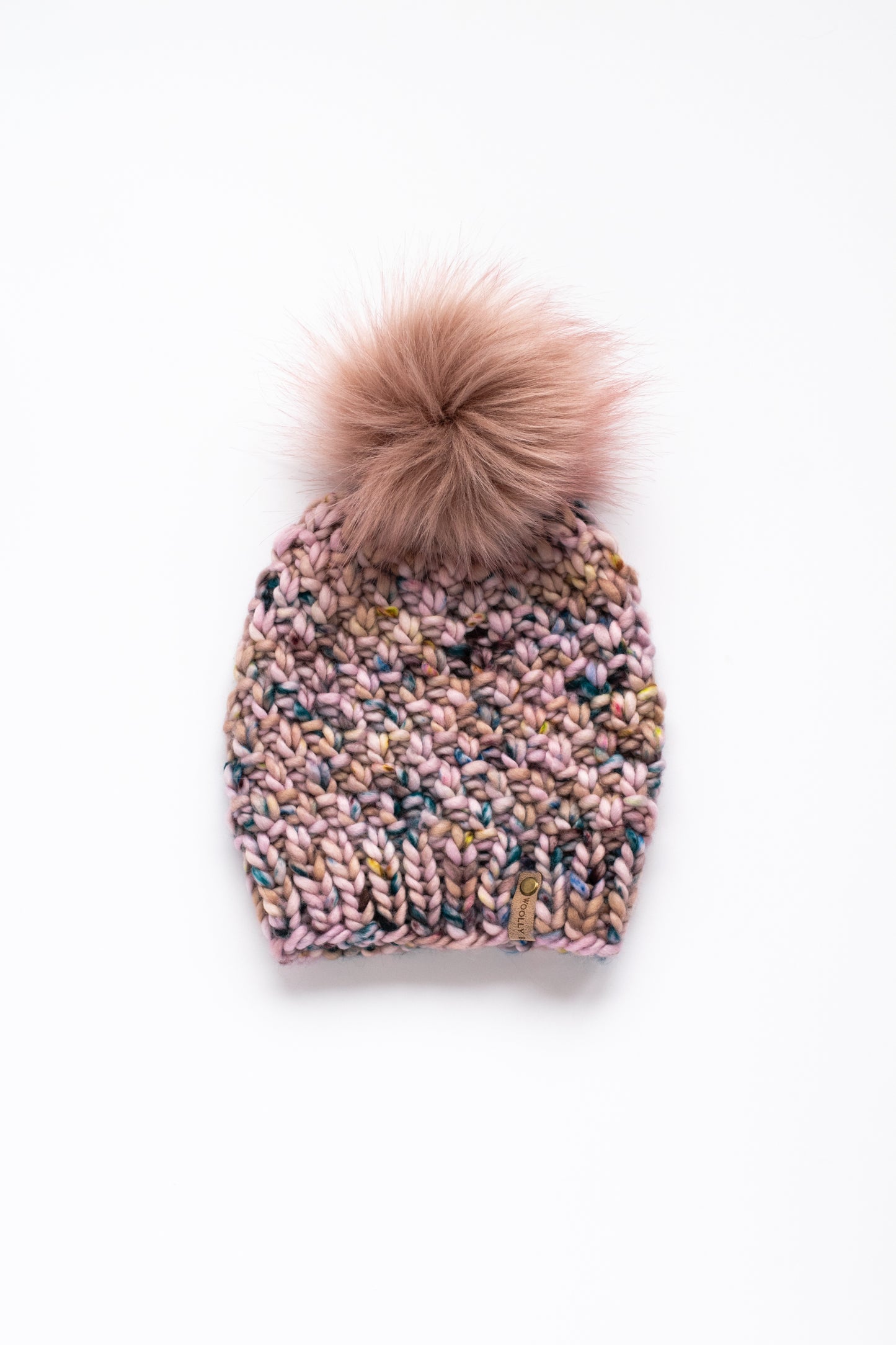 Pink knitted beanie with a pink pom-pom on a white background