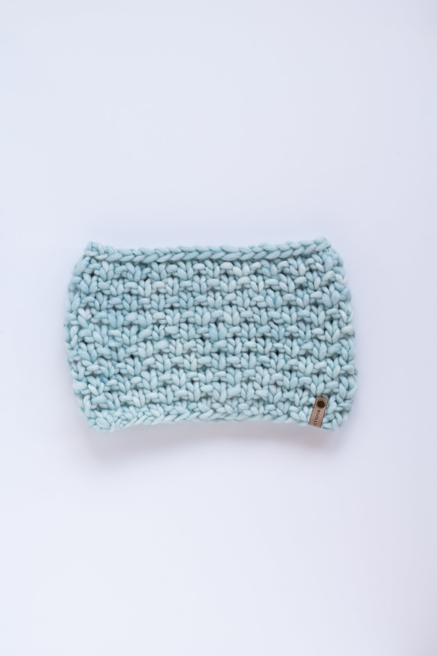 Light blue knitted scarf on a white background