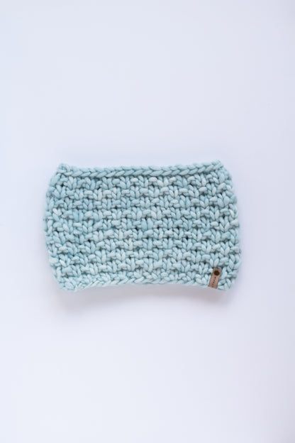 Light blue knitted scarf on a white background