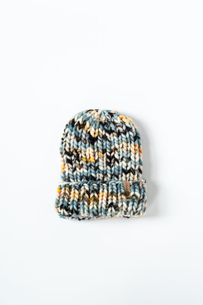 Knitted beanie with multicolor pattern on a white background