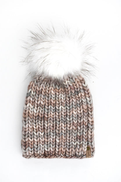 Gray ribbed knit hat with a fluffy white pom pom on a white background